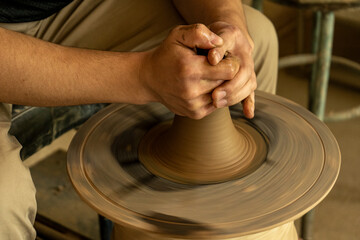 a man making a pot by clay