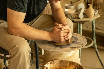 a man making a pot in a traditional way