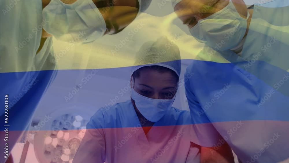 Canvas Prints Animation of waving colombia flag over team of diverse surgeons performing surgery at hospital