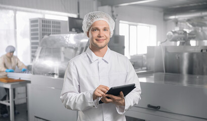 Chocolate factory worker inspecting production line conveyor with sweets candy. Concept food...