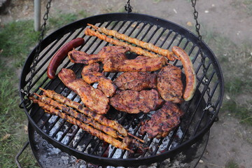 various meat and sausages on the charcoal grill