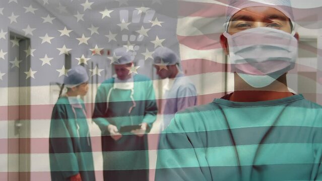 Animation of american flag over diverse surgeons