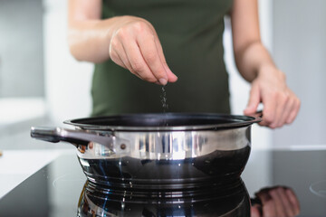 young woman performing household chores in the kitchen, lifestyle concept