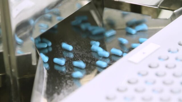 Pharmaceutical industry close up. Pills and tablets production. Medical factory equipment