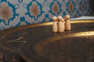 wooden figurines of people on the table. subject photo session of humanoid toys in the room. wooden...