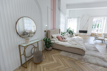 spacious open-plan apartment with stylish modern bright design, dressing area, bedroom, living room and bathroom on a sunny day