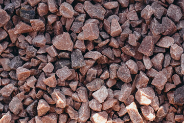 Texture of pinkish granite rubble. Top view, close-up. Place for text.