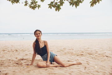 Fototapeta na wymiar woman beach smile sand vacation travel nature sea alone sitting freedom