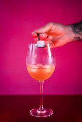 preparing an alcohol drink with ice cube 