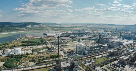 Fototapeta na wymiar carbon footprint. Close up Aerial Industrial zone in Europe with smoke is poured from the factory pipe. Pollution of the environment. Anamorphic scope 2.39 ratio