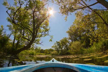  View from Kayak on calm waters with surrounding green