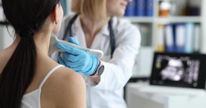 Doctor with a probe on a woman's neck, close-up. Ultrasound of lymph nodes, diagnosis of oncological diseases