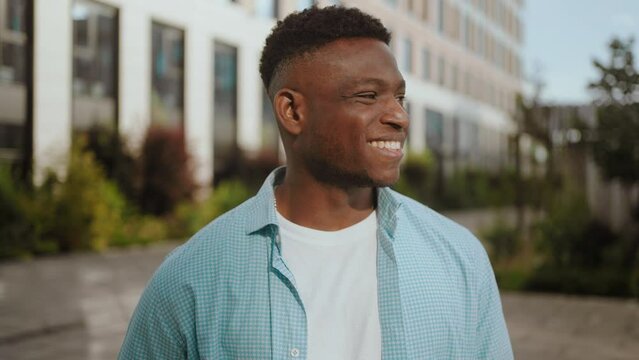 Positive African American man smiles looking at camera