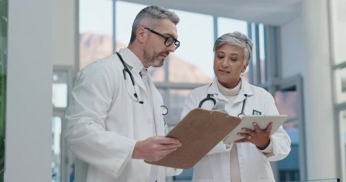 Teamwork, tablet or senior doctors in a discussion for medical or healthcare feedback, review or results. Talking, teamwork or mature leader in conversation with nursing worker meeting in hospital