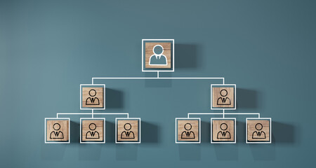 Company hierarchical organizational chart of wooden cubes on blue background. Human resources...