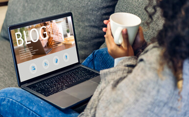 African woman ues laptop computer with social media online content, freelance worker, working...