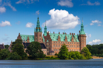 Naklejka premium Summer, sunny and warm view of Hillerod Castle in Denmark. There is a beautiful garden around the castle and it is worth visiting this place while in this area.