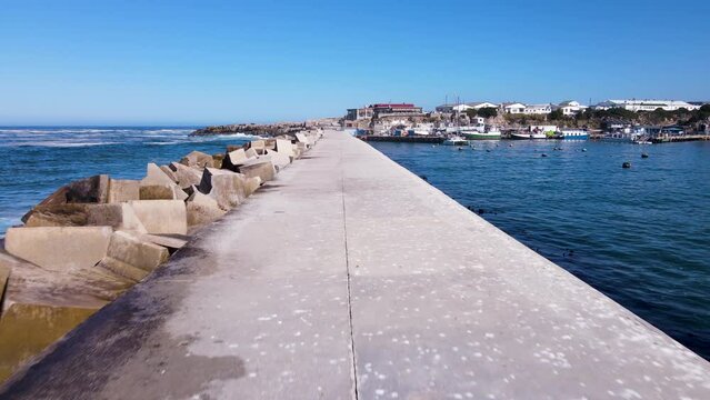 New Harbour pier with reinforced concrete dolosse on one side, drone dolly