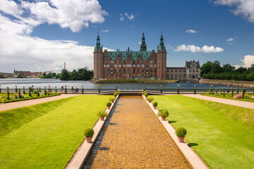 Summer, sunny and warm view of Hillerod Castle in Denmark. There is a beautiful garden around the...