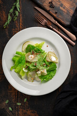Summer green salad with pears, nuts and cottage cheese. Diet dish for vegans, top view