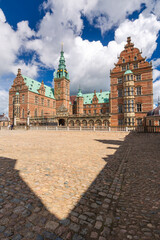 Fototapeta premium Summer, sunny and warm view of Hillerod Castle in Denmark. There is a beautiful garden around the castle and it is worth visiting this place while in this area.