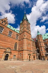 Fototapeta premium Summer, sunny and warm view of Hillerod Castle in Denmark. There is a beautiful garden around the castle and it is worth visiting this place while in this area.