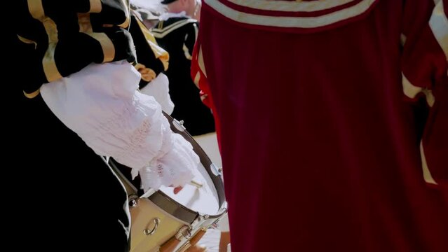 a man during the performance playing the drum while marching