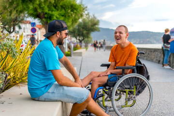 Fototapeta na wymiar A disabled person in a wheelchair with a friend on summer vacation having fun laughing a lot