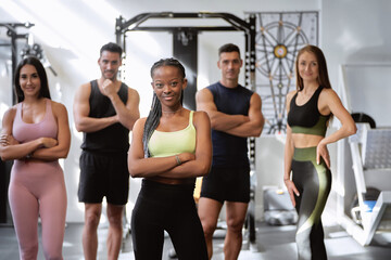 african fitness woman posing on camera with her group of fitness friends of different ethnicities