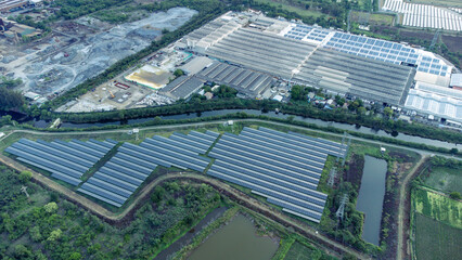 Solar cells farming beside with rivers and factories in industrial area. Green World concept with...