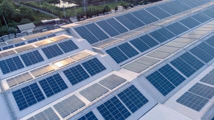 Aerial view of solar roof of the factory in eco environment. Solar Cells panel reflection with the sun and turn to blue color in industrial area. Concept of energy recycle.