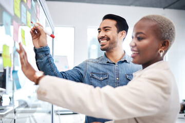 Happy creative people, writing and glass board for schedule planning, strategy or brainstorming at...