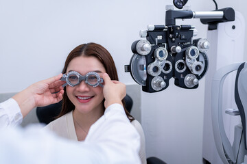 Woman optical shop customer doing eyesight measurement with optical phoropter check eye distance...