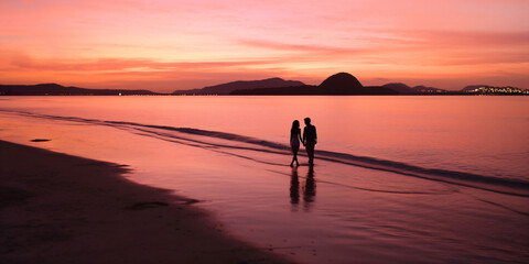 couple walking along the sea shore, generative ai