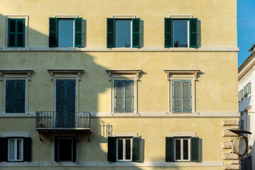 Renaissance balcony on a mediterranean building with shutters