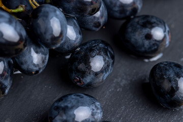 sweet ripe black grapes covered with drops of water