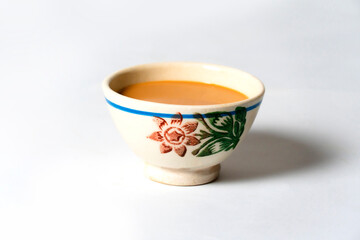 Fresh milk tea or indian karak chai in payali or masala tea in clay cup on white background