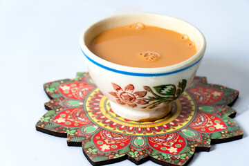 Fresh milk tea or indian karak chai in payali or masala tea in clay cup on white background
