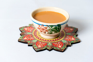 Fresh milk tea or indian karak chai in payali or masala tea in clay cup on white background