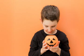 Halloween orange background with caucasian boy