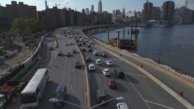 alt flying over FDR Drive traffic til ting up on midtown NYC skyline