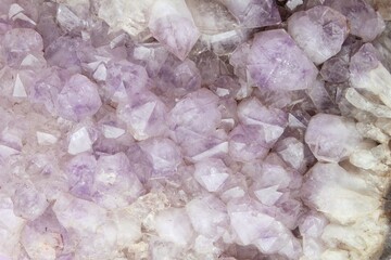 Close-up of natural violet amethyst druse geode mineral crystal unpolished semi-precious gemstone. Magic rock for ritual, witchcraft, spiritual practice, meditation. Esoteric life balance concept