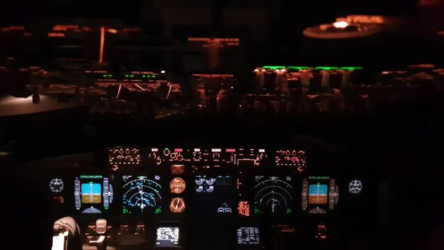Cockpit of airplane with illuminated instruments at night. handheld