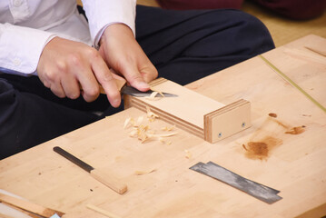 Japanese craftsman making a bamboo spatula, an important tool for working with Japanese lacquer urushi. Handmade arts and crafts.