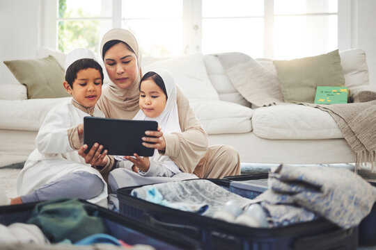 Travel, Tablet And Muslim Family With Suitcase Packing For Holiday, Vacation And Religious Trip. Home, Luggage And Mom With Kids On Digital Tech And Clothes In Bag For Journey, Adventure And Tourism