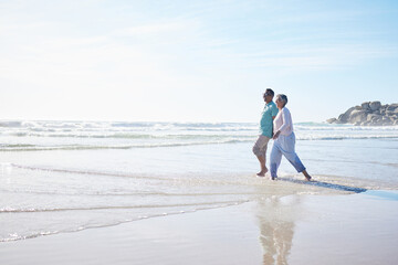 Beach, walking and senior couple holding hands for bonding, quality time and relax in nature. Love, retirement and happy elderly man and woman by ocean on holiday, vacation and travel in morning