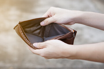 Close up hands hold empty wallet with no money.  Concept, poor, bad economic crisis. Financial...
