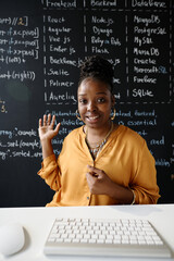 Vertical image of African American teacher using laptop for online study