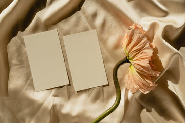 Blank paper sheet cards with mockup copy space, rattan casket and poppy flower with aesthetic...