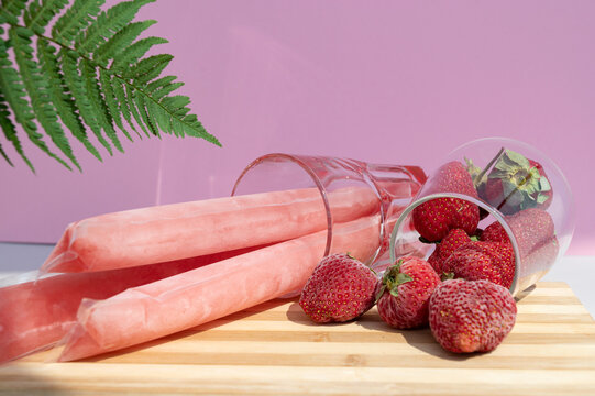 Ice cream in a bag with strawberries, sweet frozen homemade. Brazilian Dindin, chup-chup